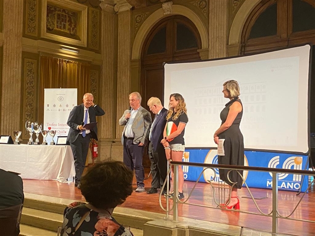 Francesco Cusati sul palco che parla al microfono con a fianco  Rodolfo Masto, Martina Rabbolini, la presentatrice e dall'altra parte Massimo Achini