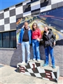 Da sinistra: Max, loredana e Coccolina sul podio con dietro una stampa dello sviluppo della pista dei Kart.